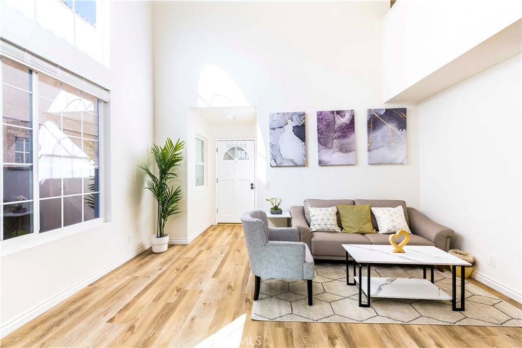 a living room with furniture and a potted plant