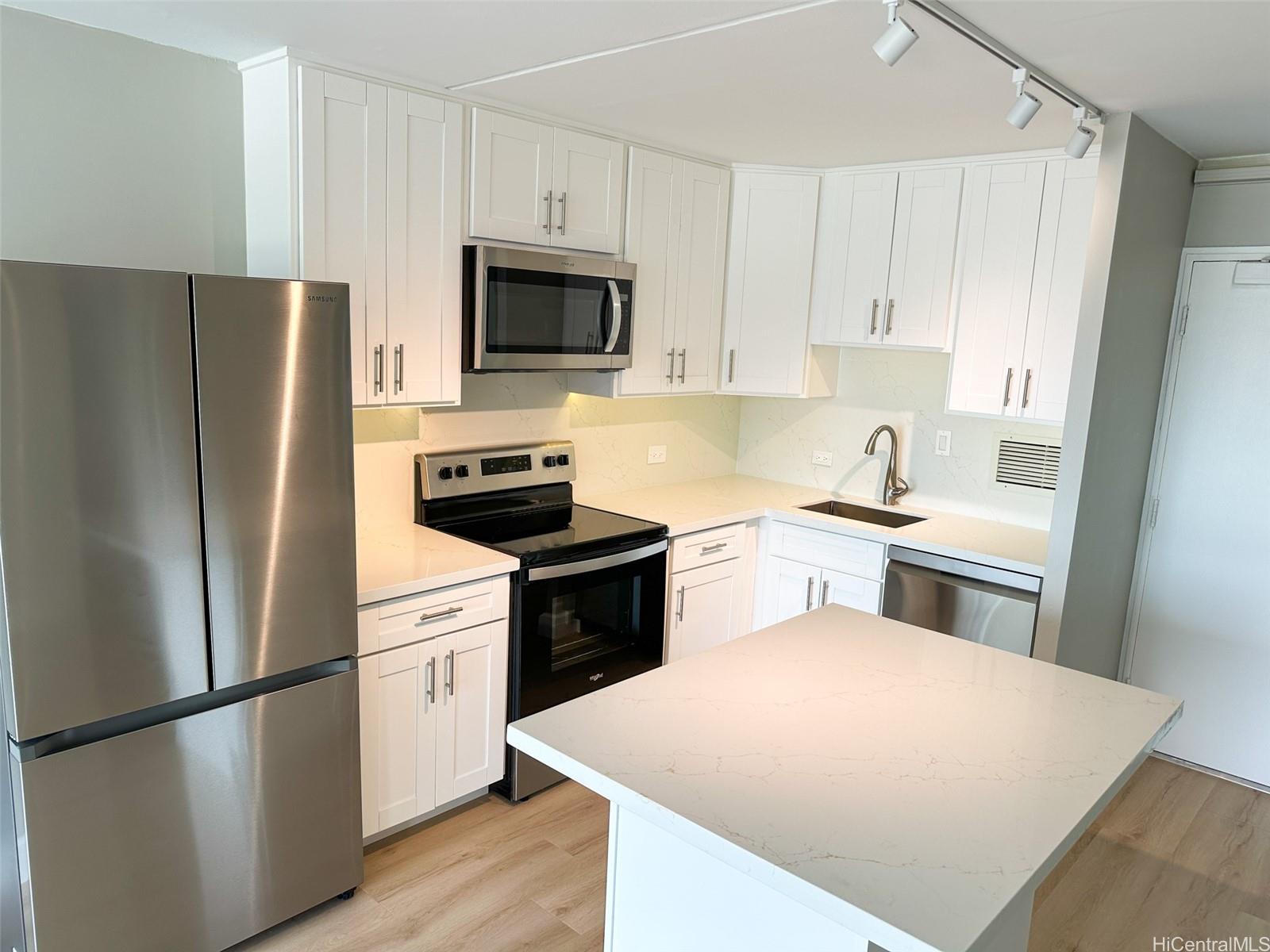 a kitchen with a refrigerator stove and microwave