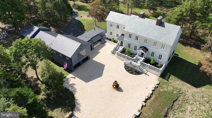 an aerial view of a house with yard and garage