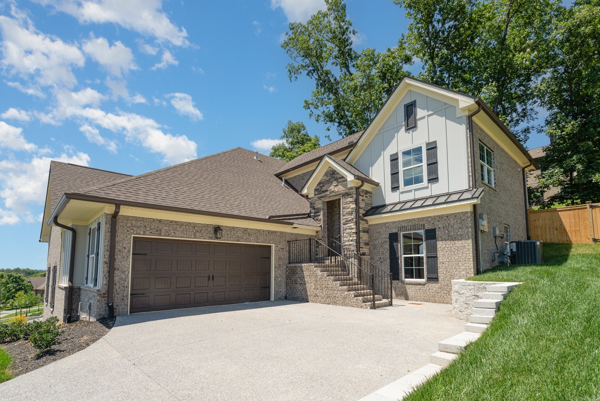 a front view of a house with yard and garage