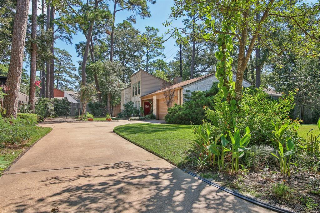 front view of a house with a yard and trees