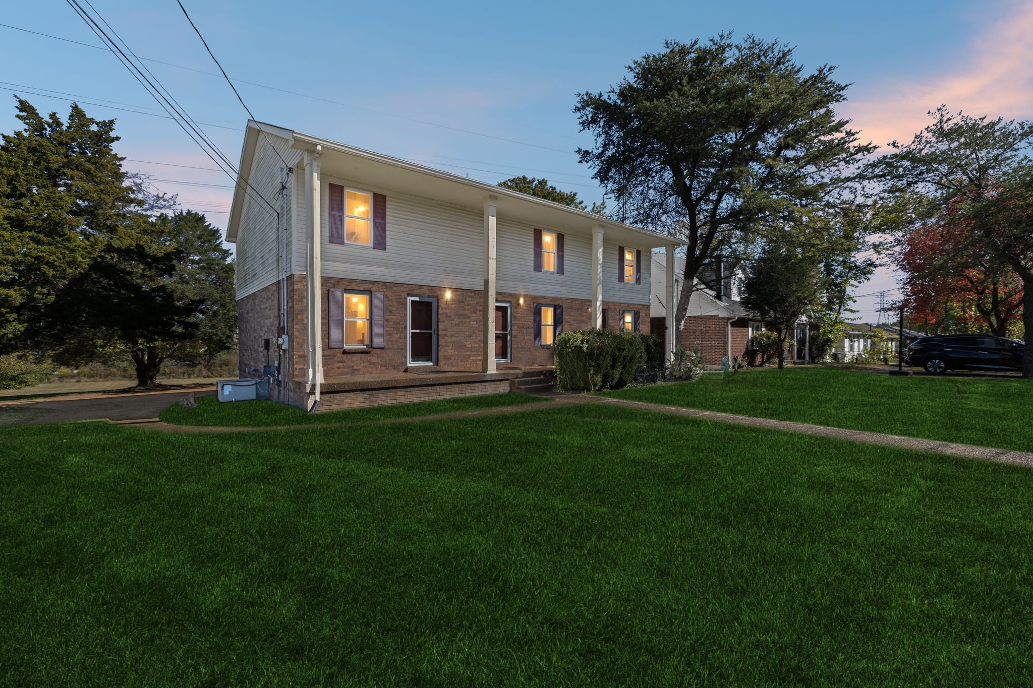 a front view of house with yard and green space