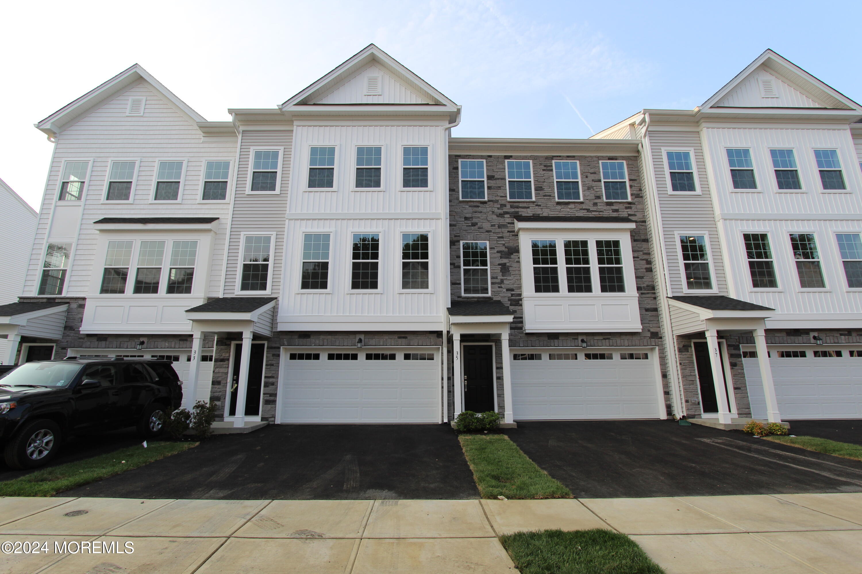 a front view of a residential apartment building with a yard