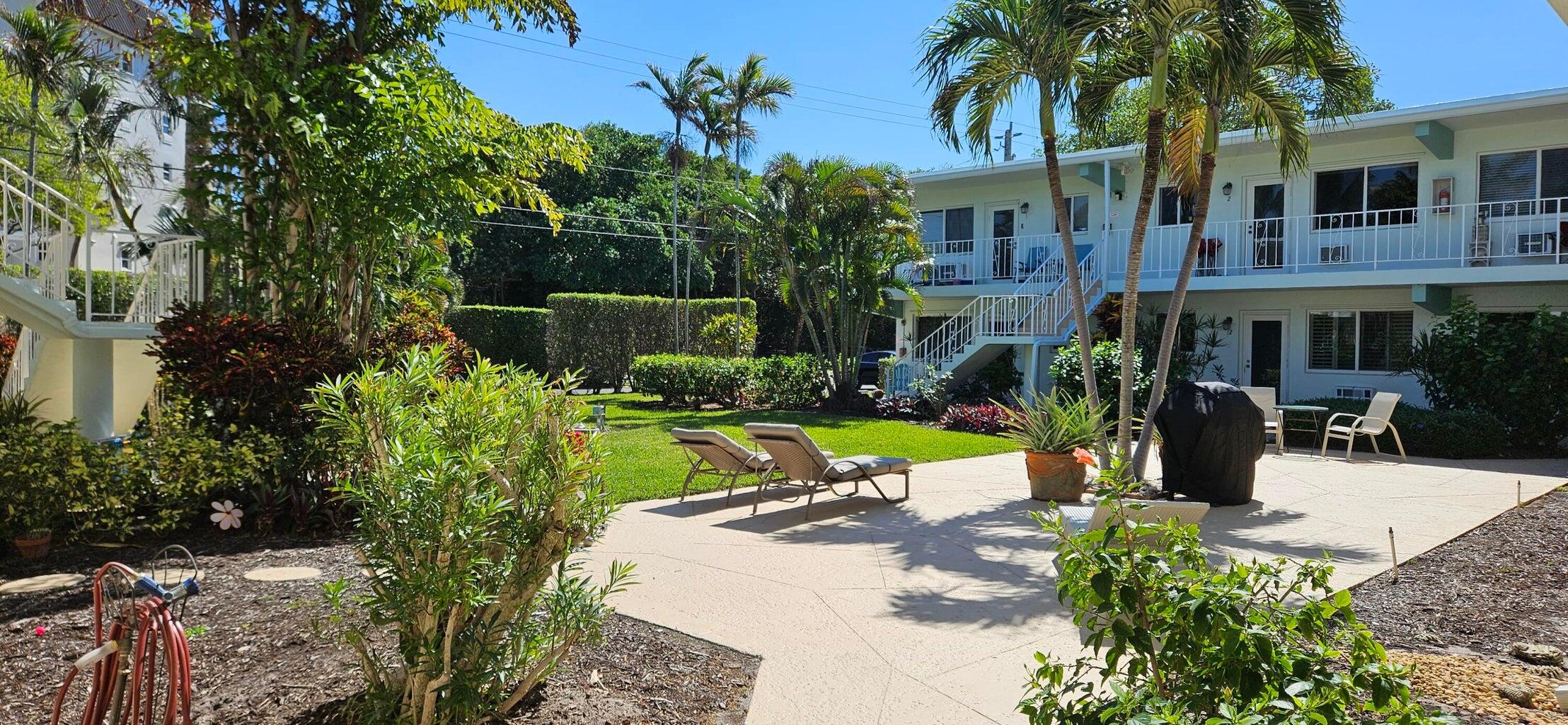 a view of a house with palm trees front of house