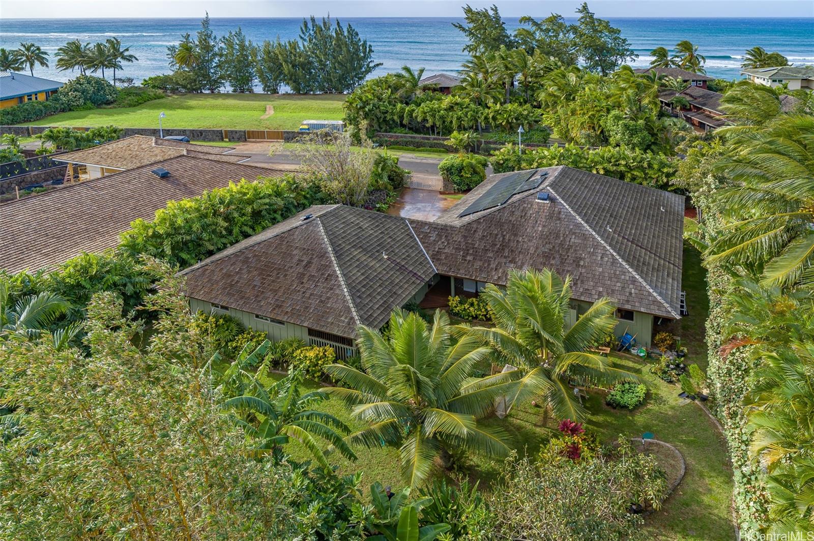 an aerial view of a house with garden space and outdoor seating