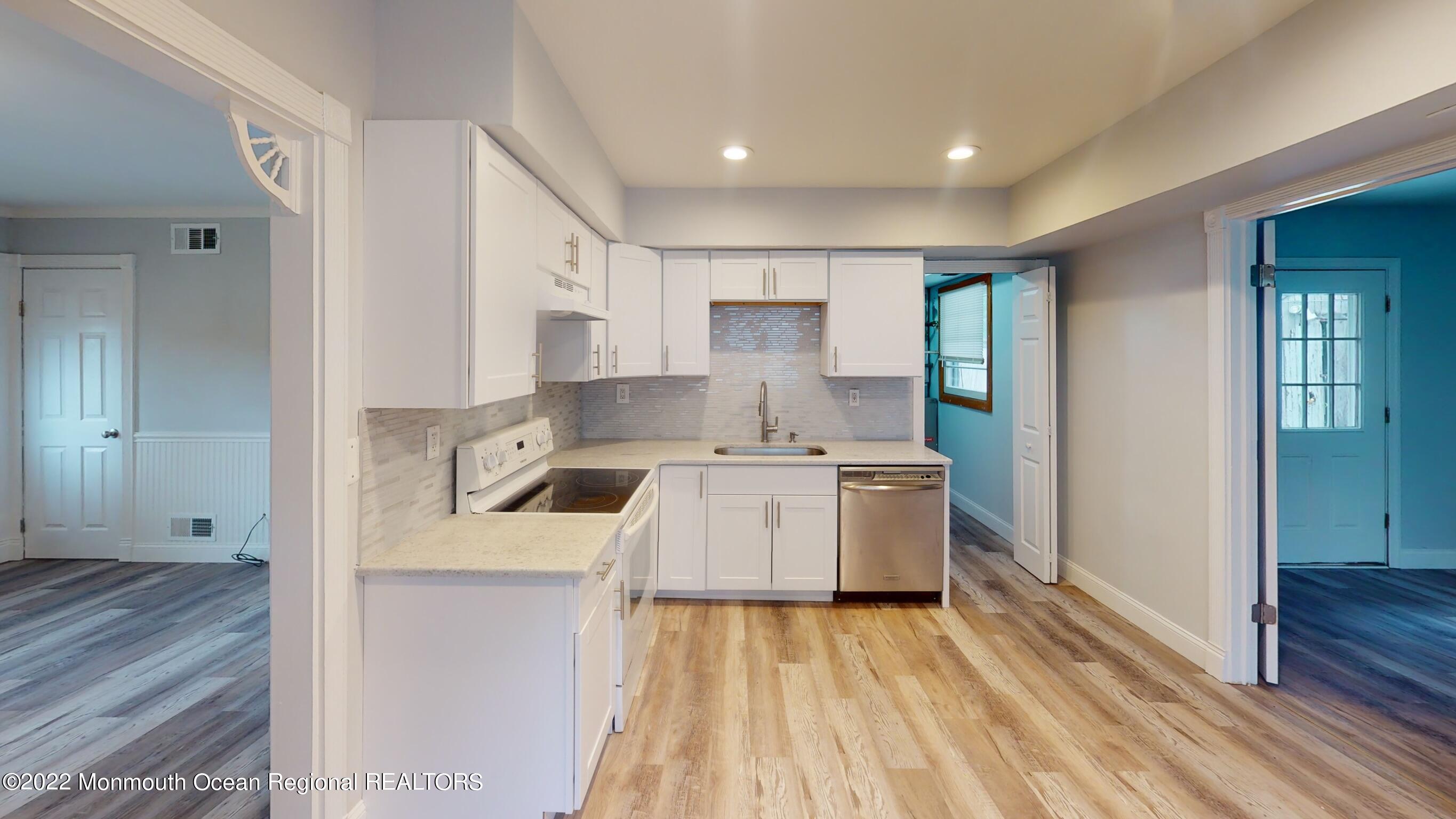 a kitchen with a stove a sink and a refrigerator