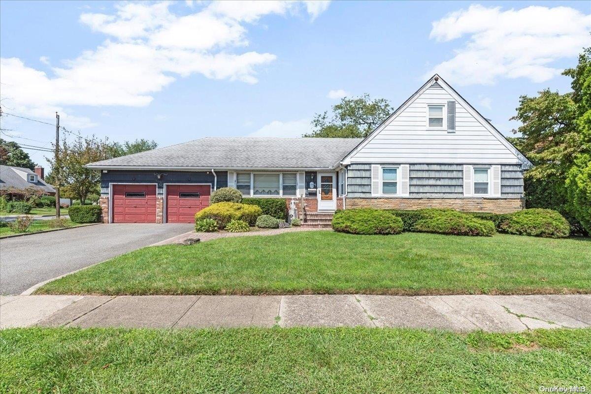 a view of front of house with a yard