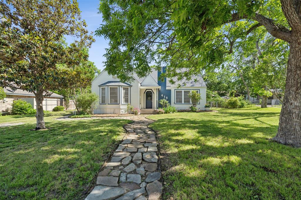 a front view of a house with a garden