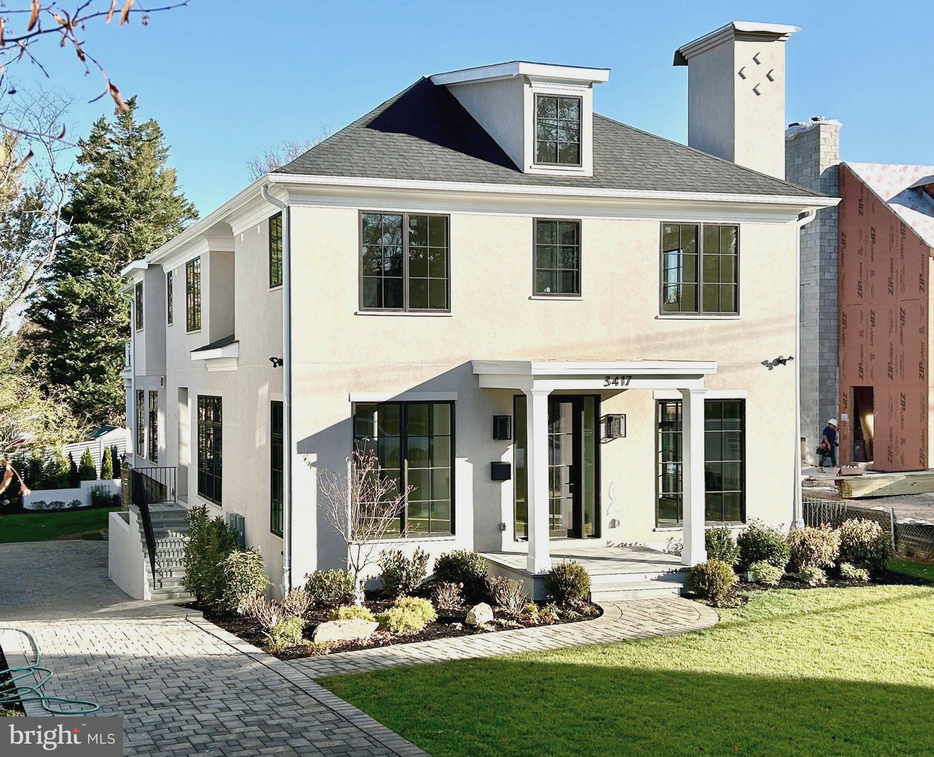 a front view of a house with yard yard and outdoor seating