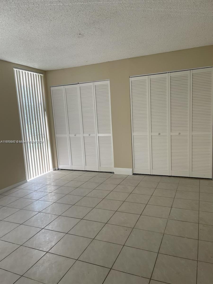 a view of an empty room and wooden floor