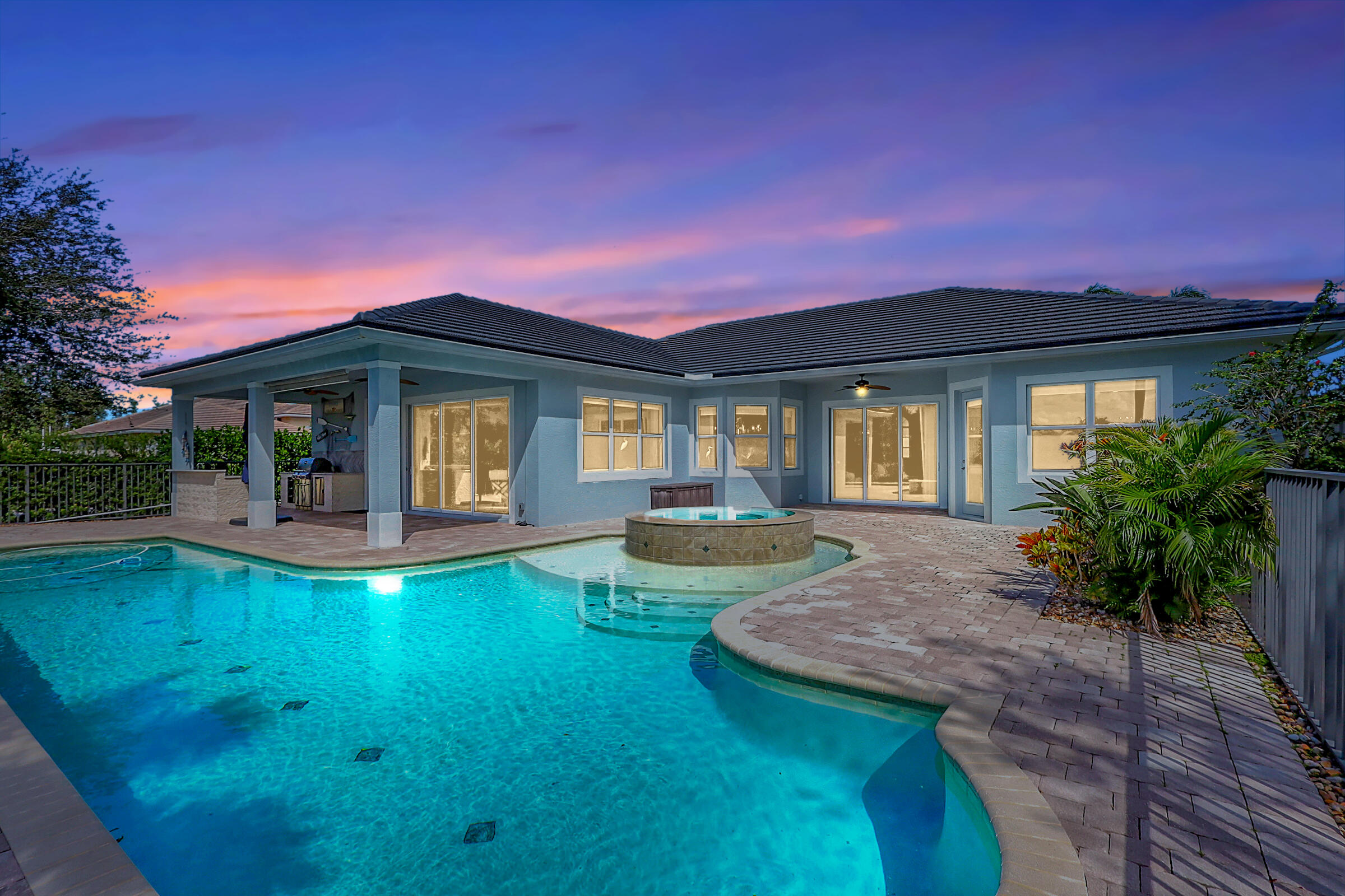 a view of a house with swimming pool and a yard