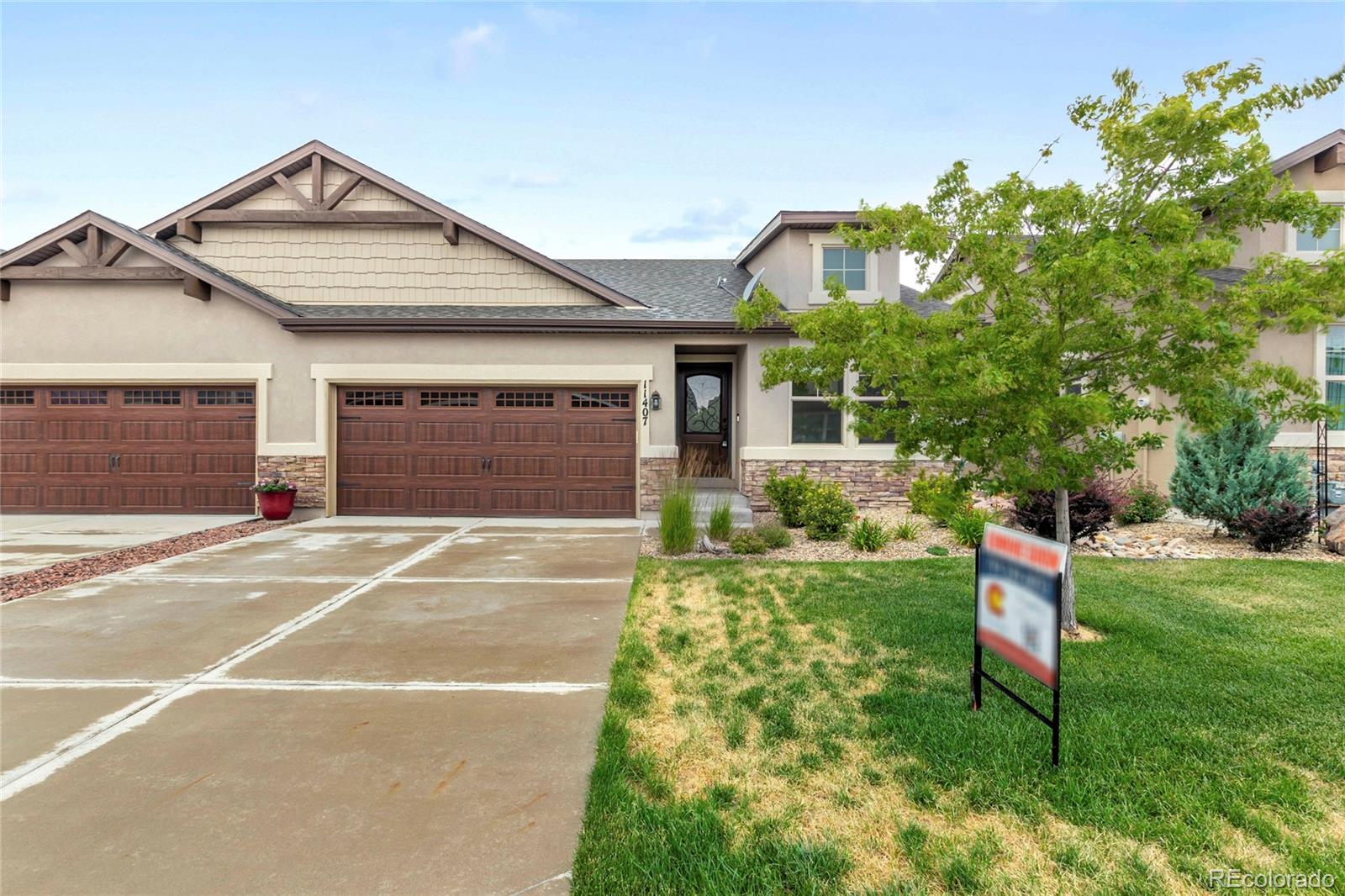 a front view of a house with a yard and garage