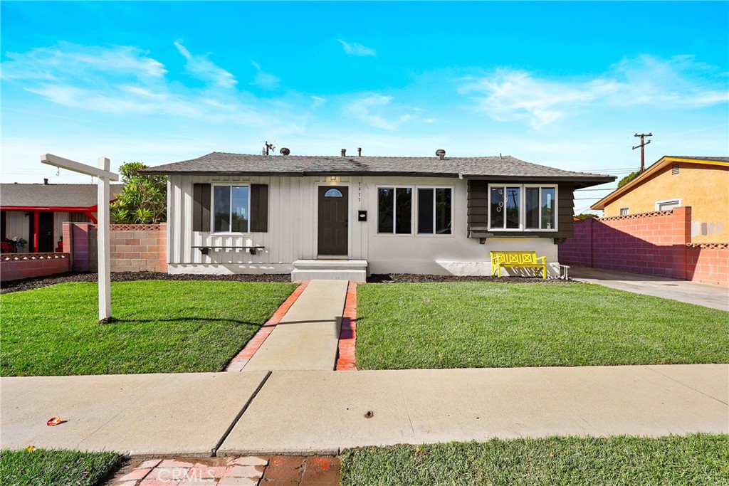 a front view of a house with a garden and yard