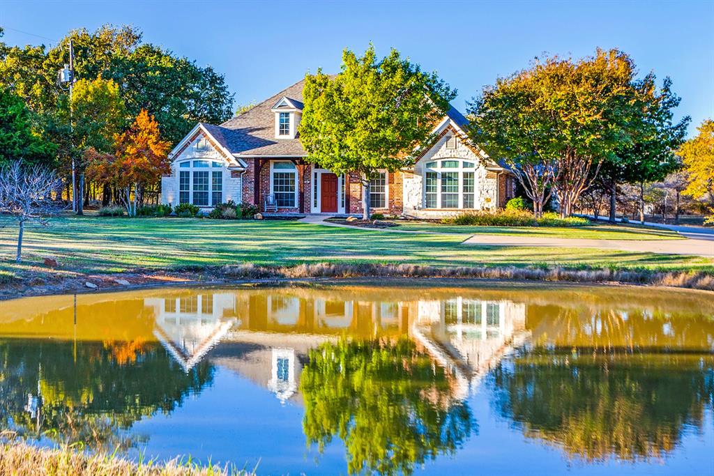 a view of a house with pool and a yard