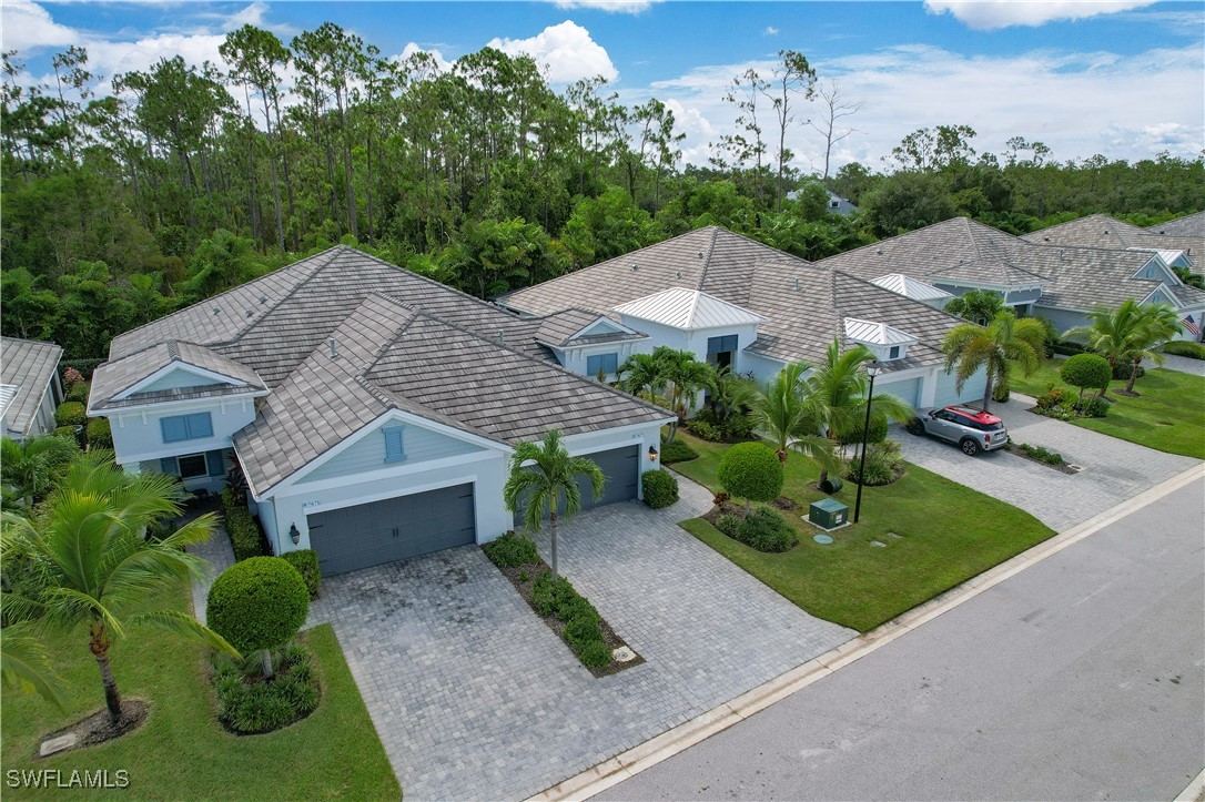 a aerial view of a house with a yard and potted plants