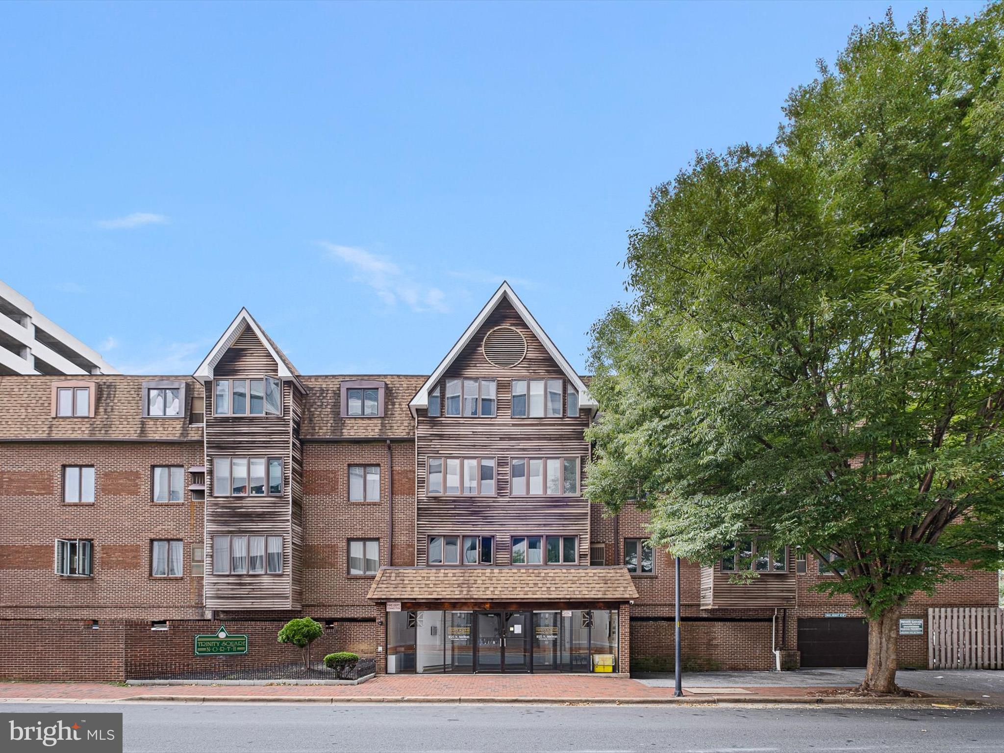 a front view of a residential apartment building with a yard