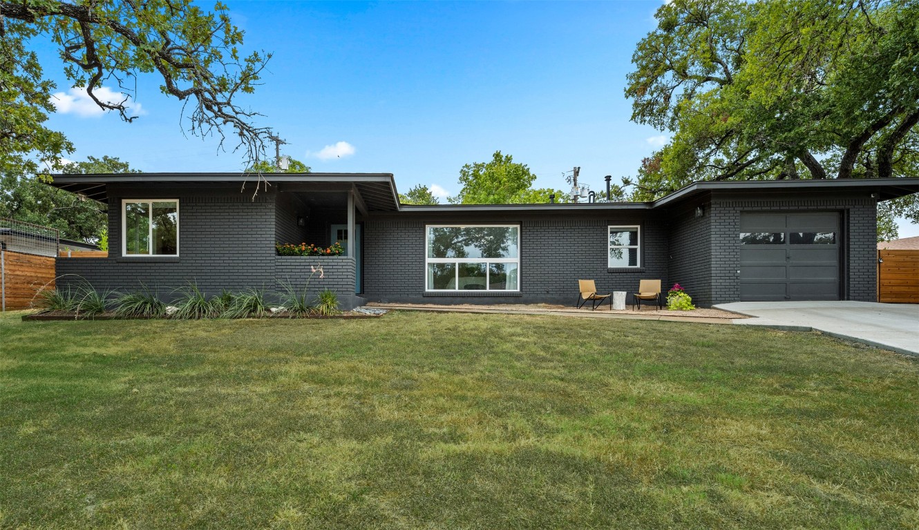 a front view of a house with a garden