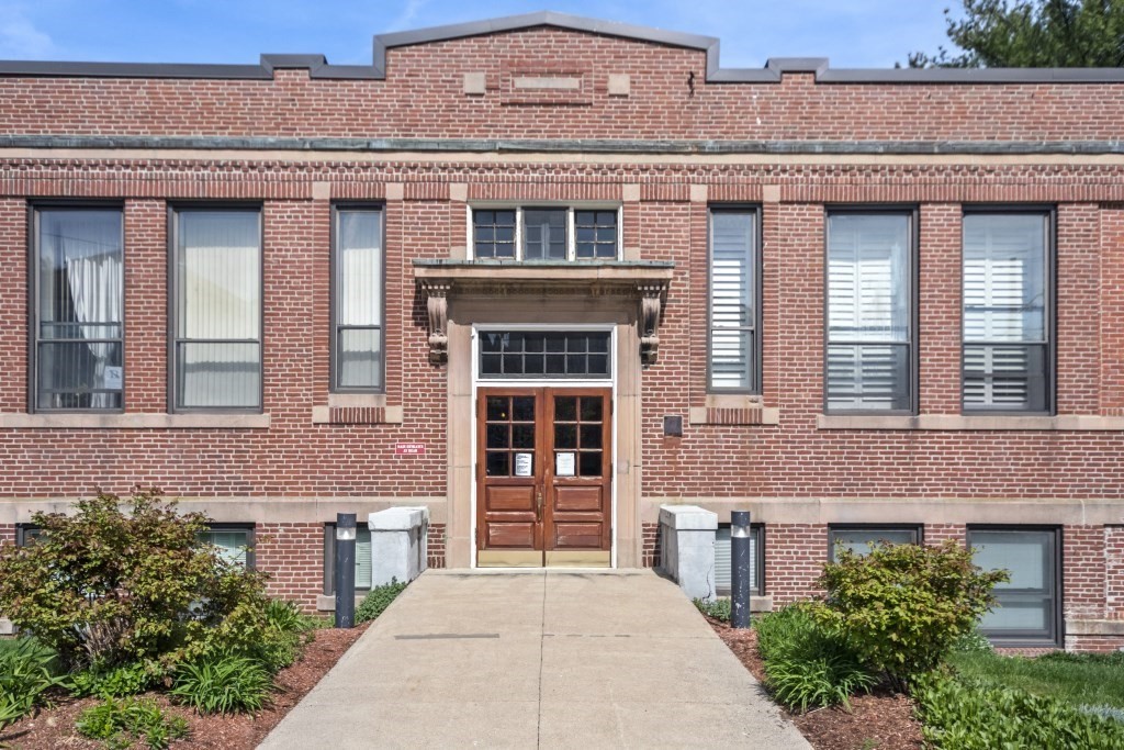 front view of a brick house with a large windows