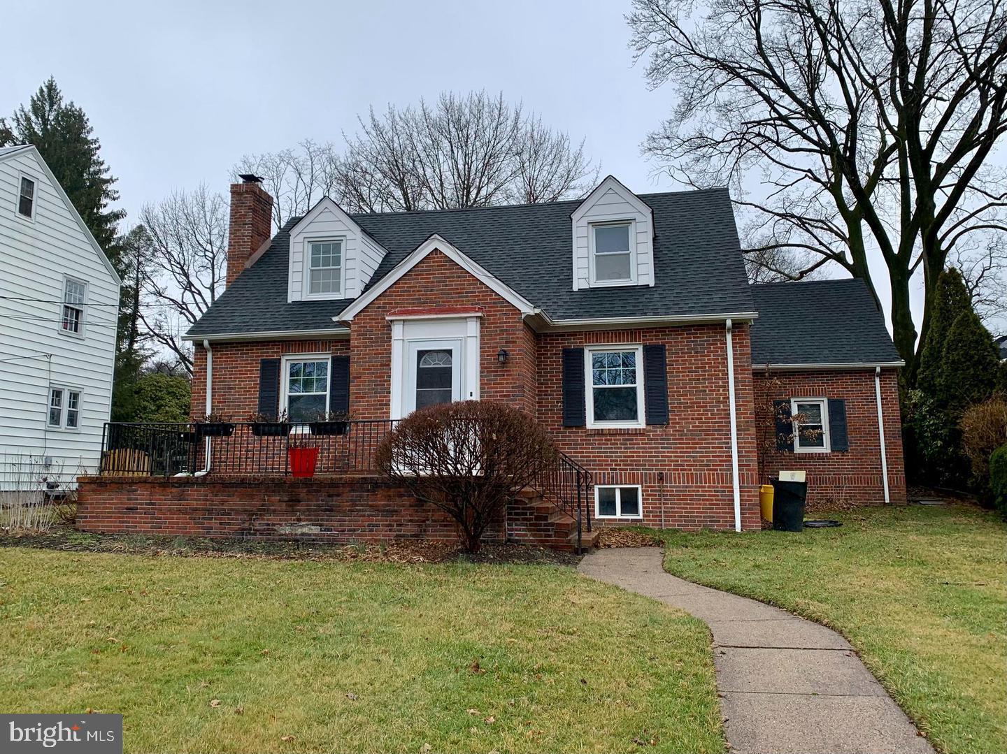 a front view of a house with a yard outdoor seating and barbeque oven