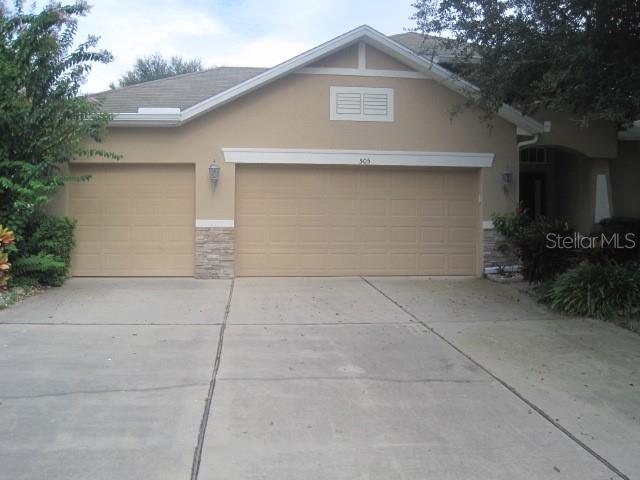 a front view of a house with garage