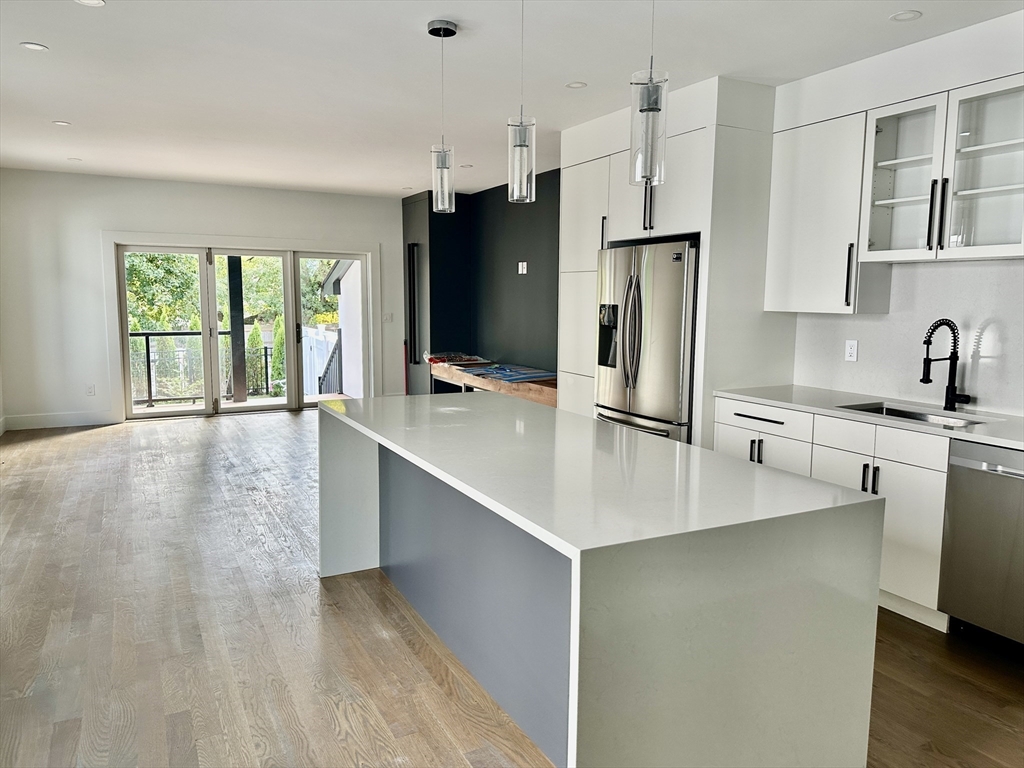 a kitchen with stainless steel appliances a refrigerator sink and cabinets