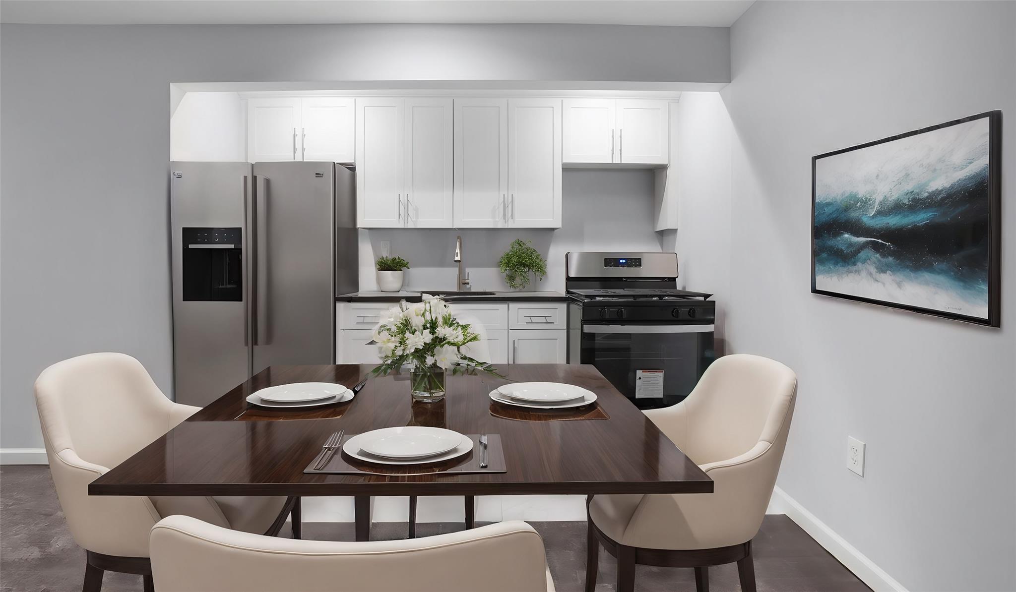 Kitchen with white cabinets, sink, and stainless steel appliances