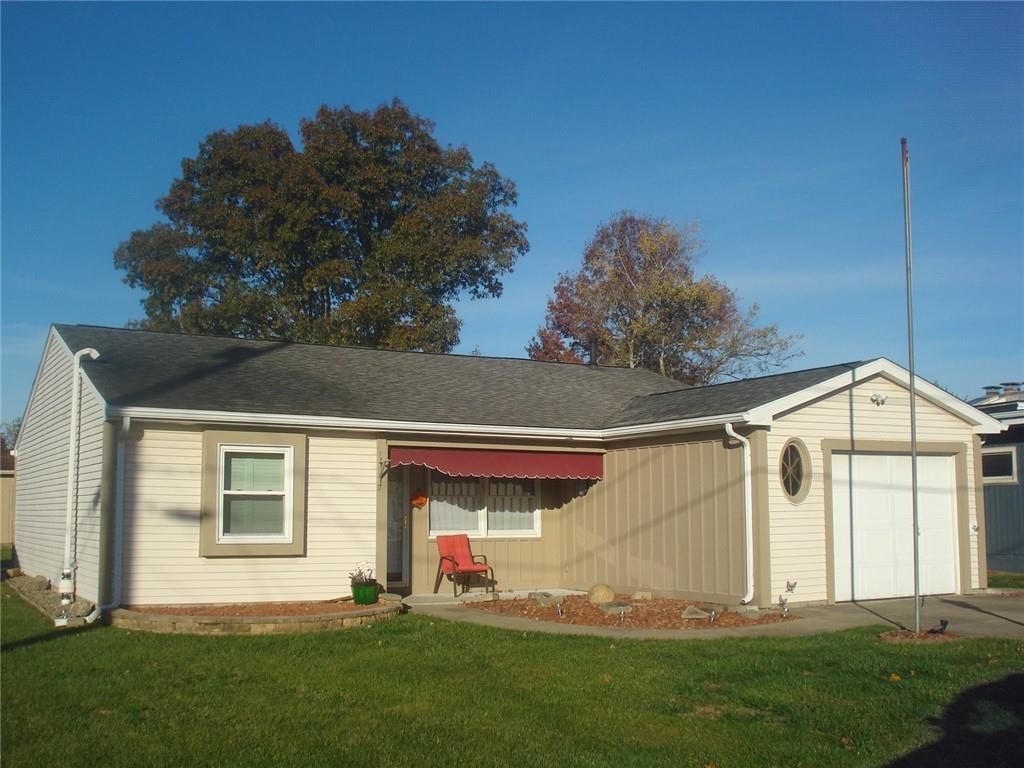 a front view of a house with a garden and plants