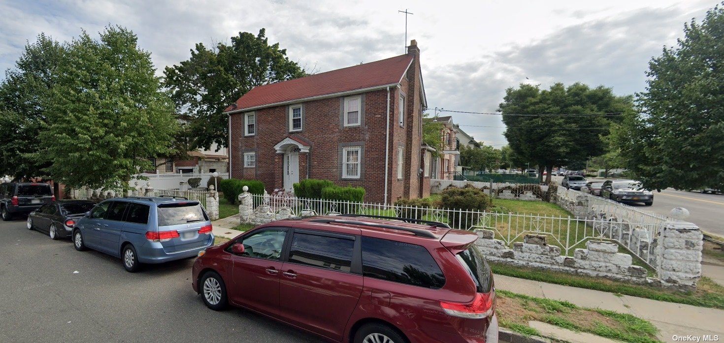 a view of a cars park in front of a building