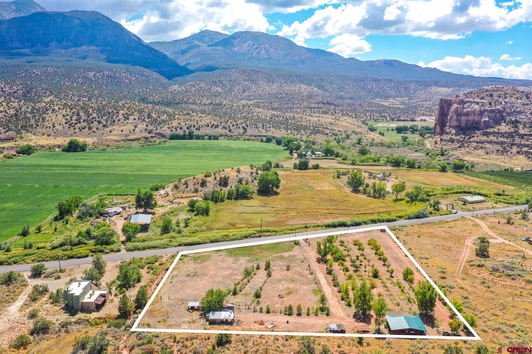 a view of a garden and mountains