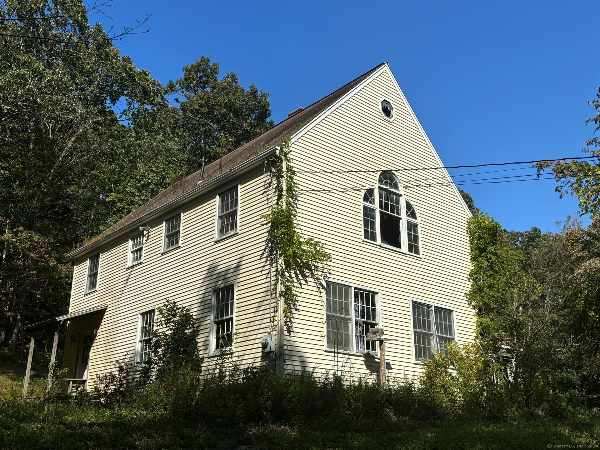 a view of a white house with a yard