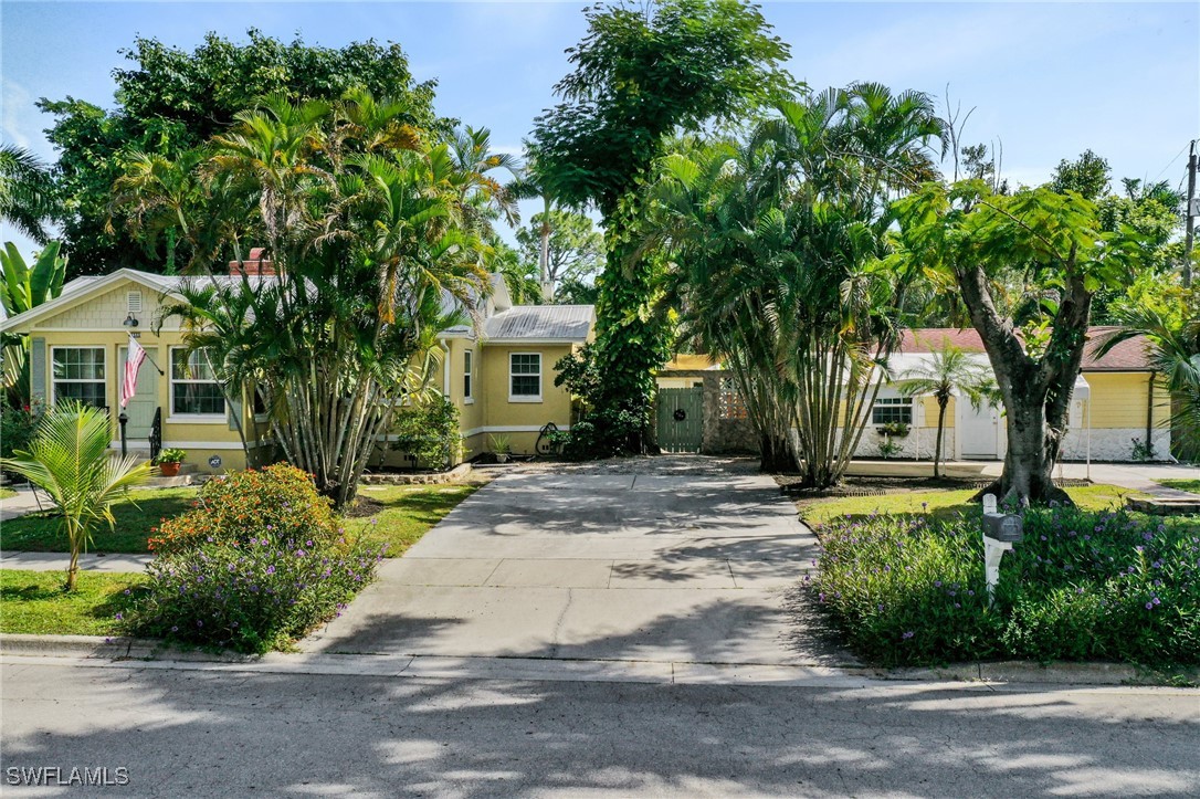 a front view of a house with a garden