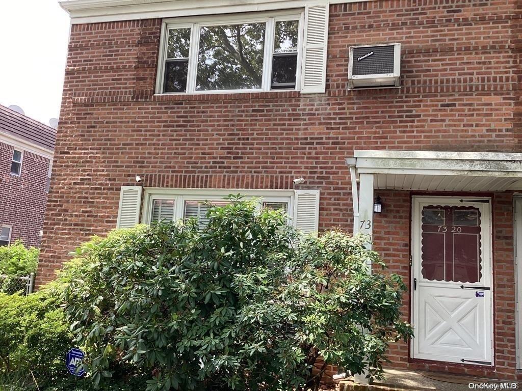 View of exterior entry featuring a wall unit AC