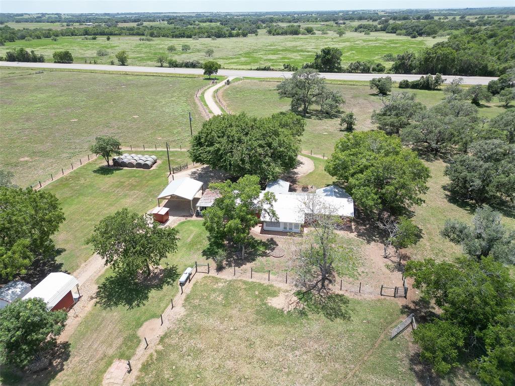 an aerial view of residential houses with outdoor space and river