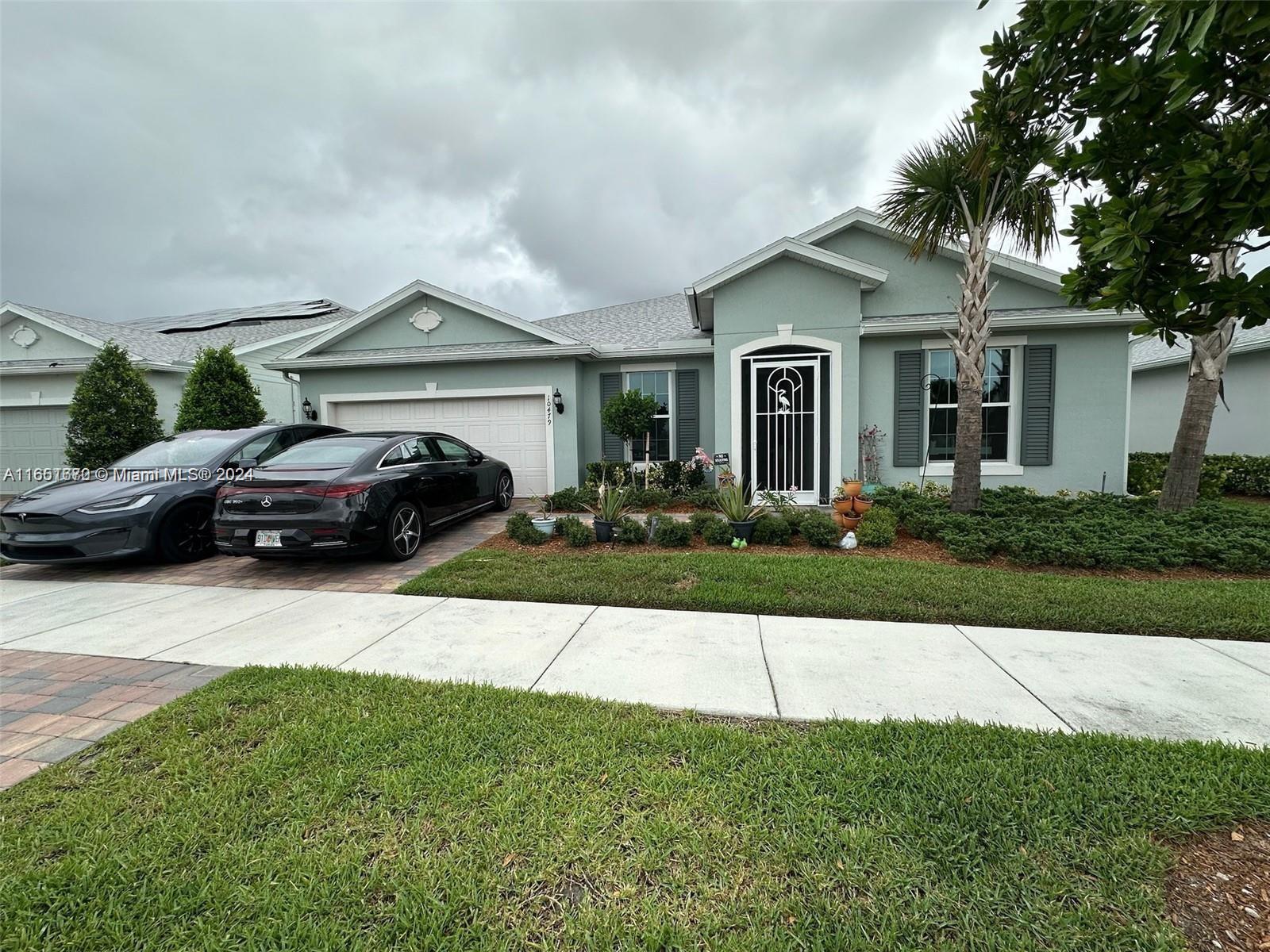 a front view of a house with a garden