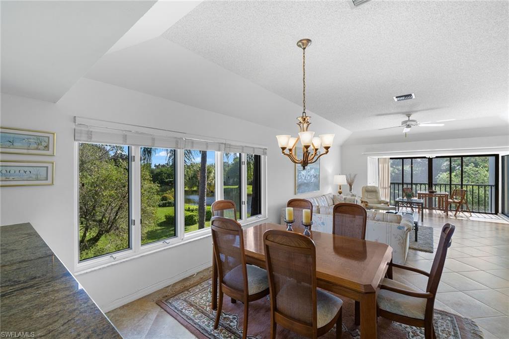 a view of a dining room with furniture wooden floor and chandelier