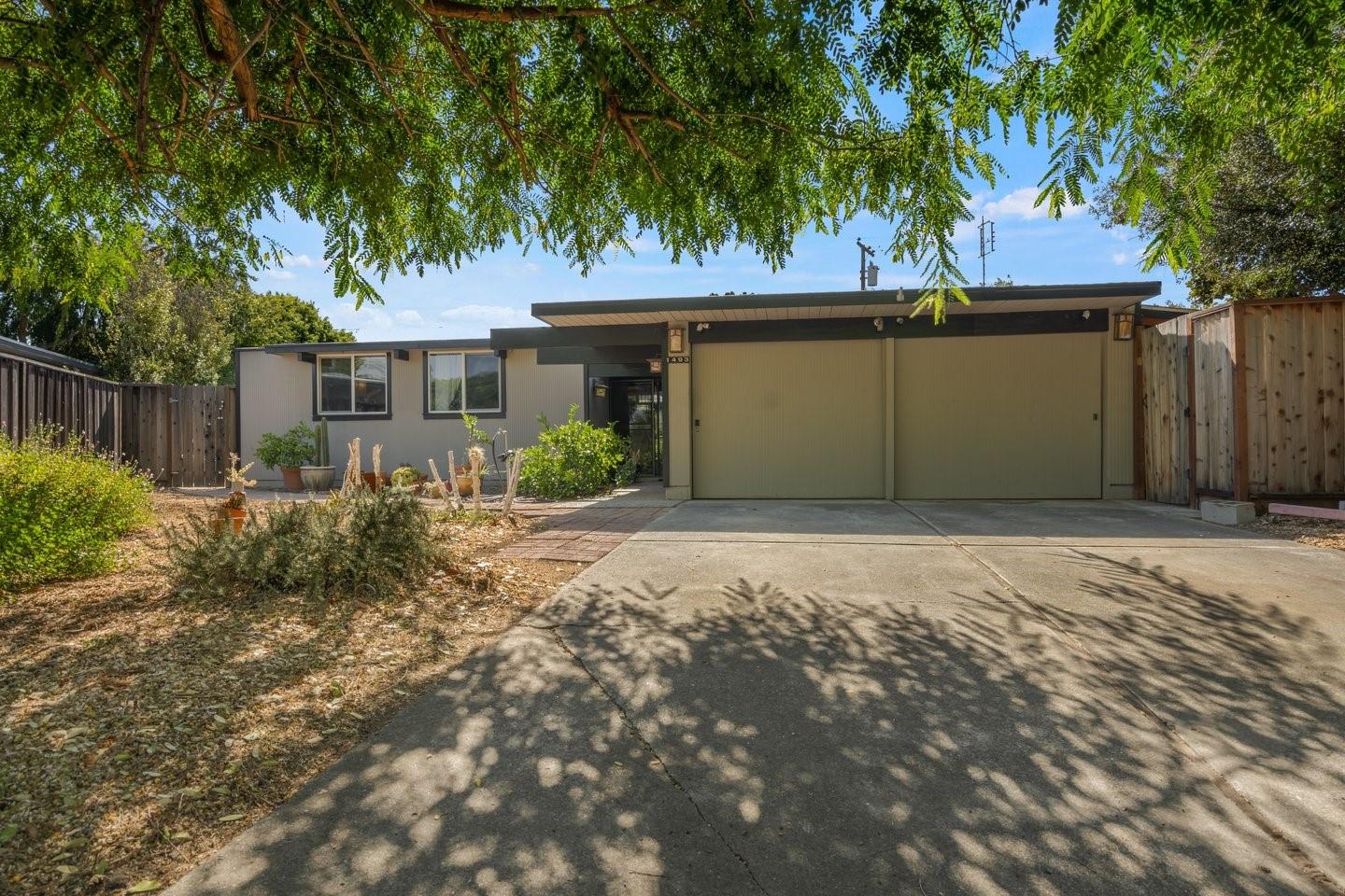 a front view of house with yard and trees