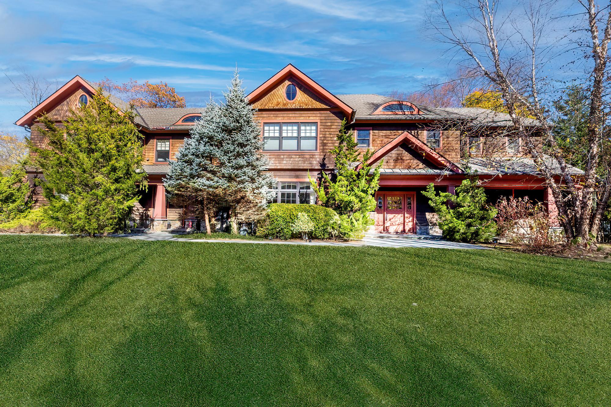 a front view of a house with a garden