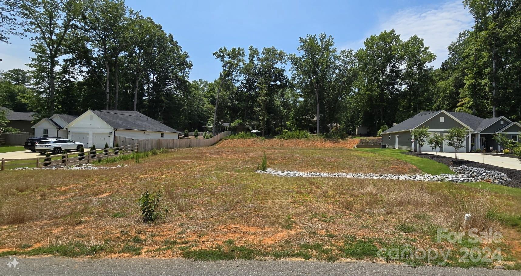 a view of a house with yard and sitting area