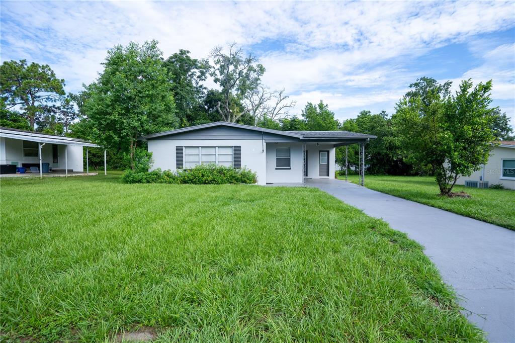 a front view of house with yard and green space