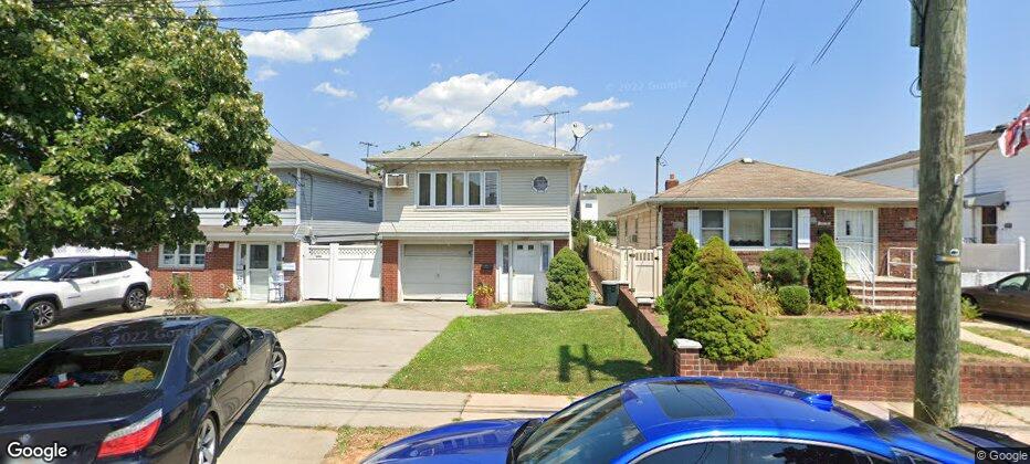 View of front of home with a garage and a front lawn