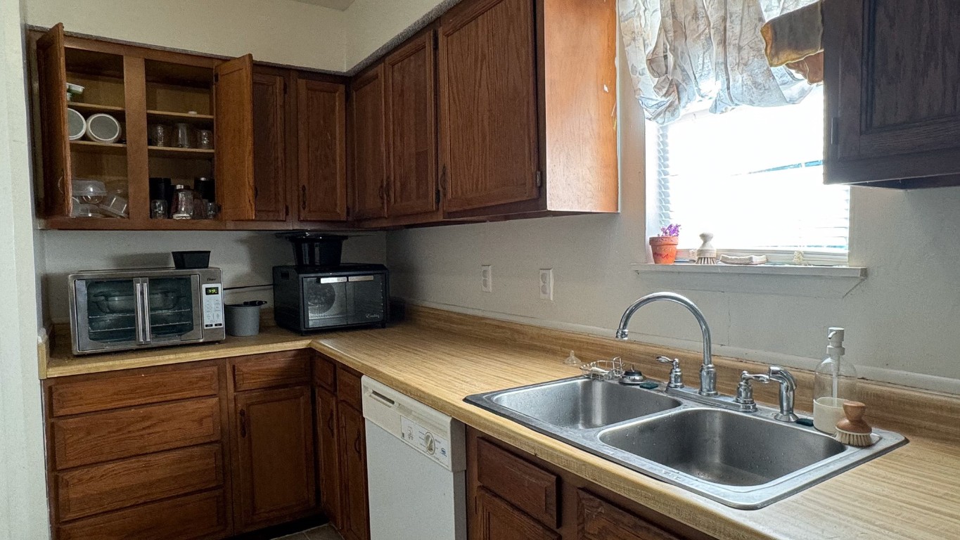 a kitchen with a sink cabinets and window