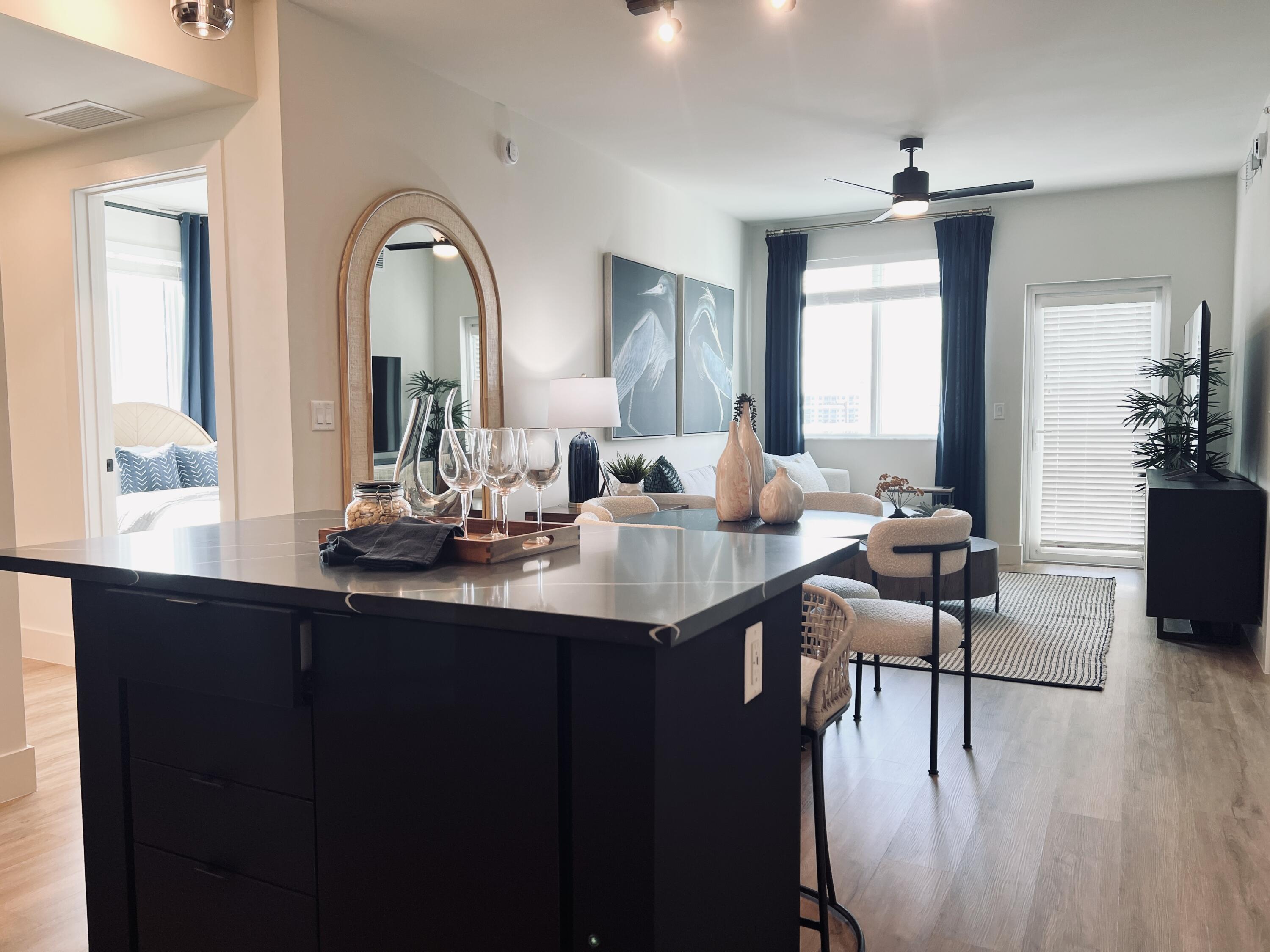 a kitchen with a table chairs sink and cabinets