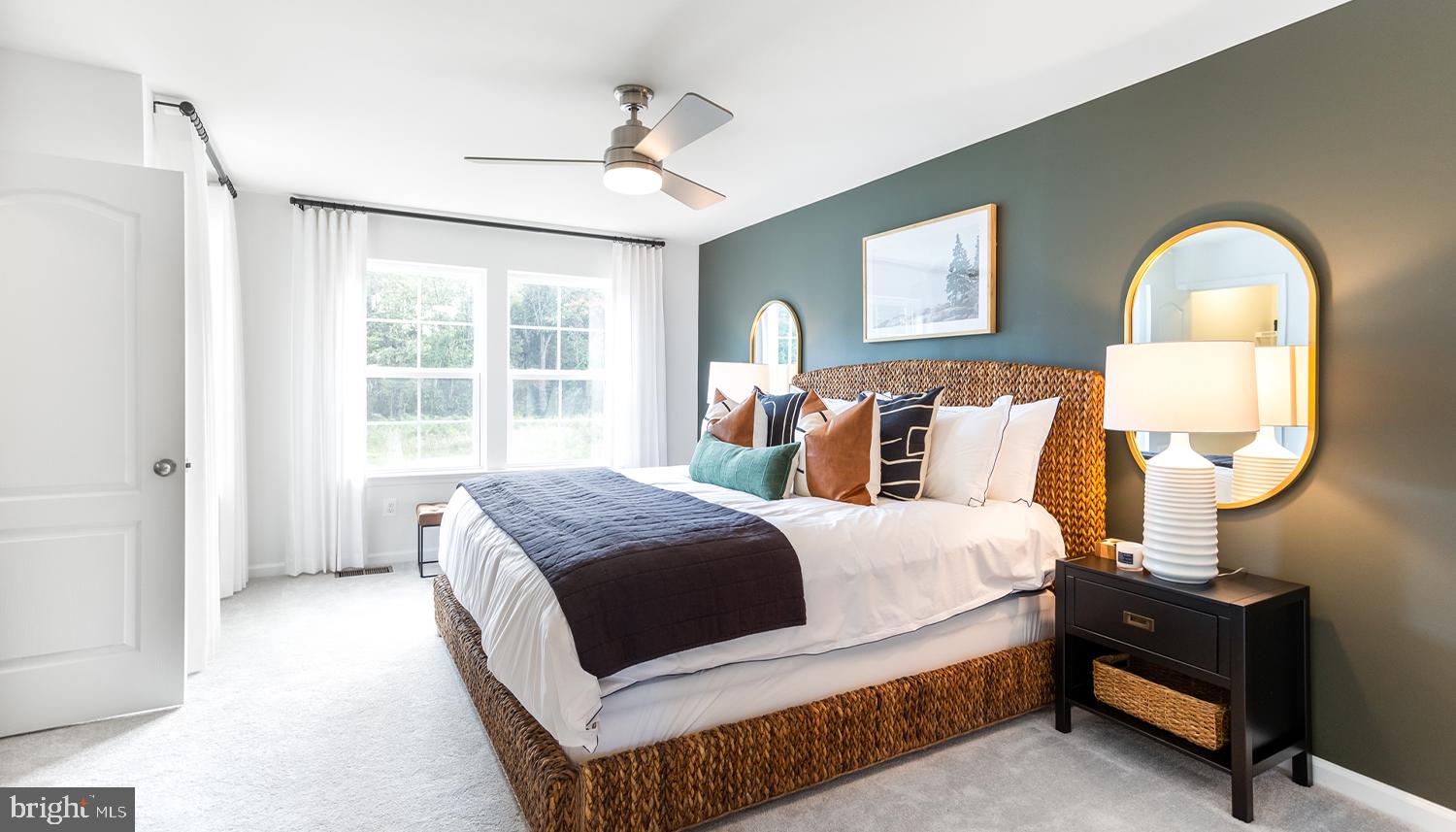 a living room with a bed furniture and a window