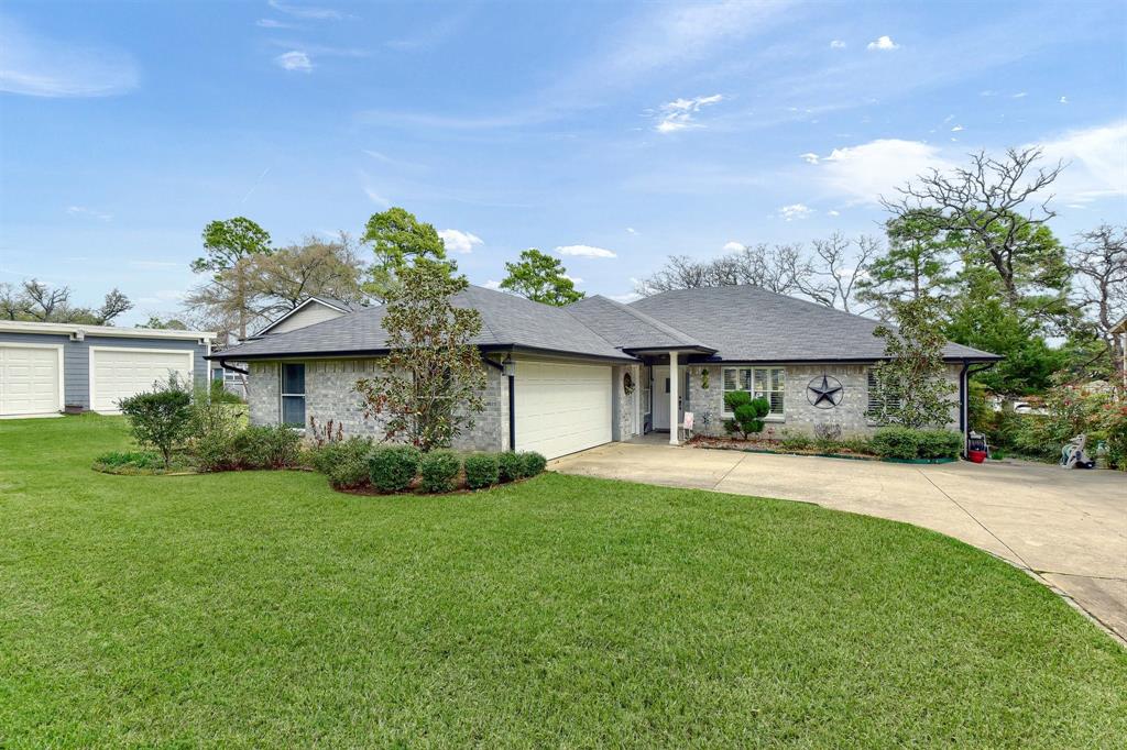 a front view of a house with a garden and plants