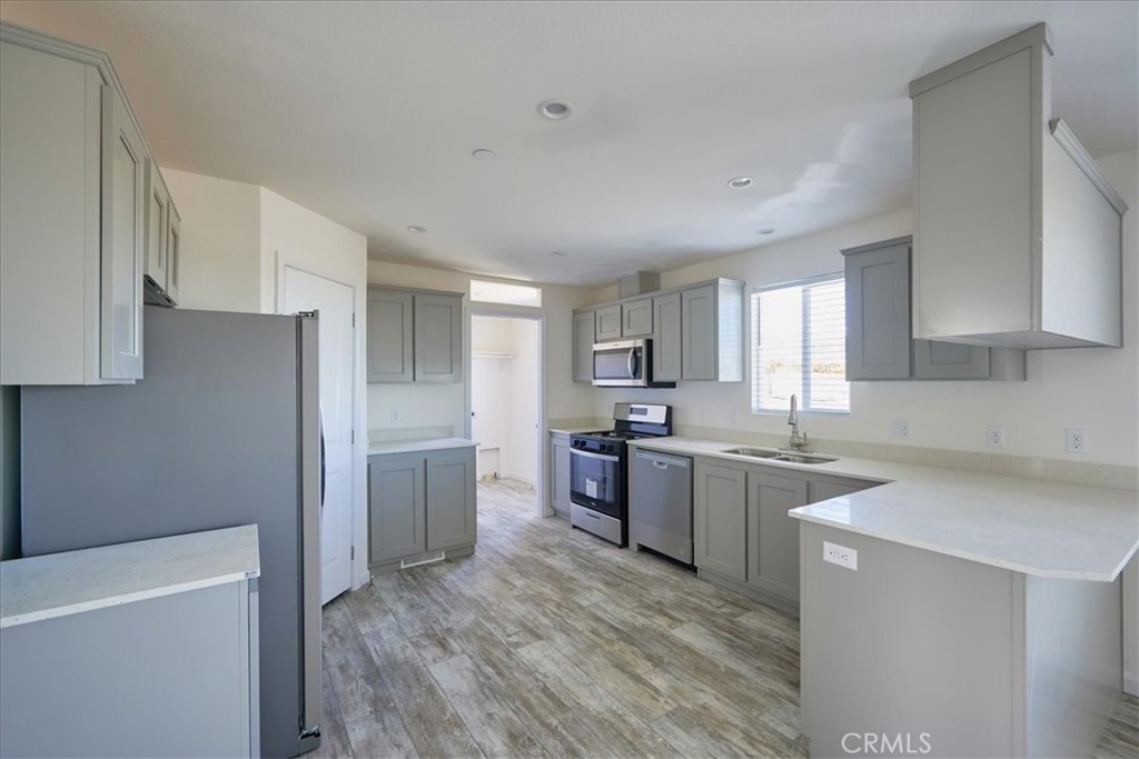 a kitchen with a sink stove top oven and refrigerator