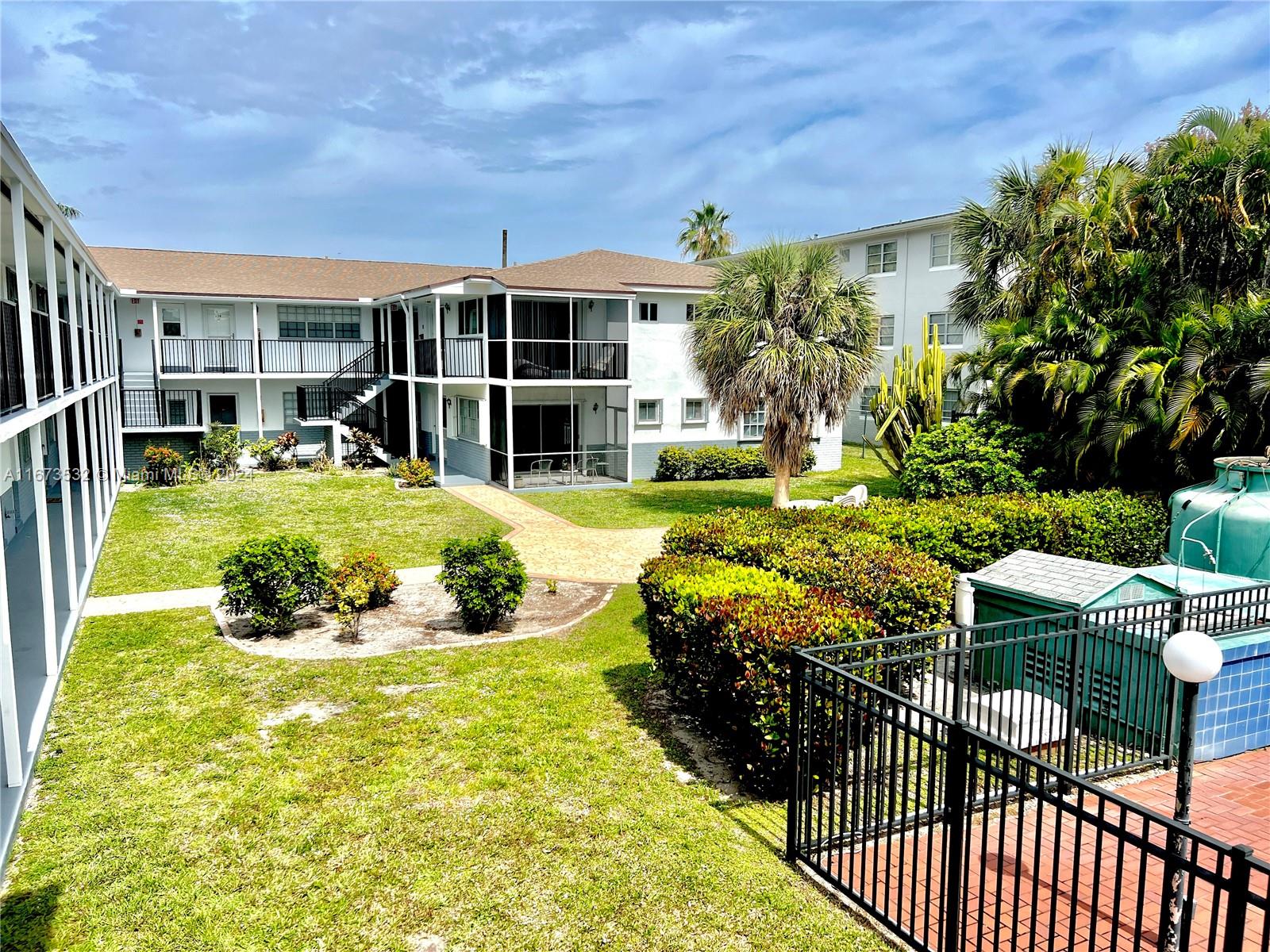 a view of a house with backyard porch and sitting area