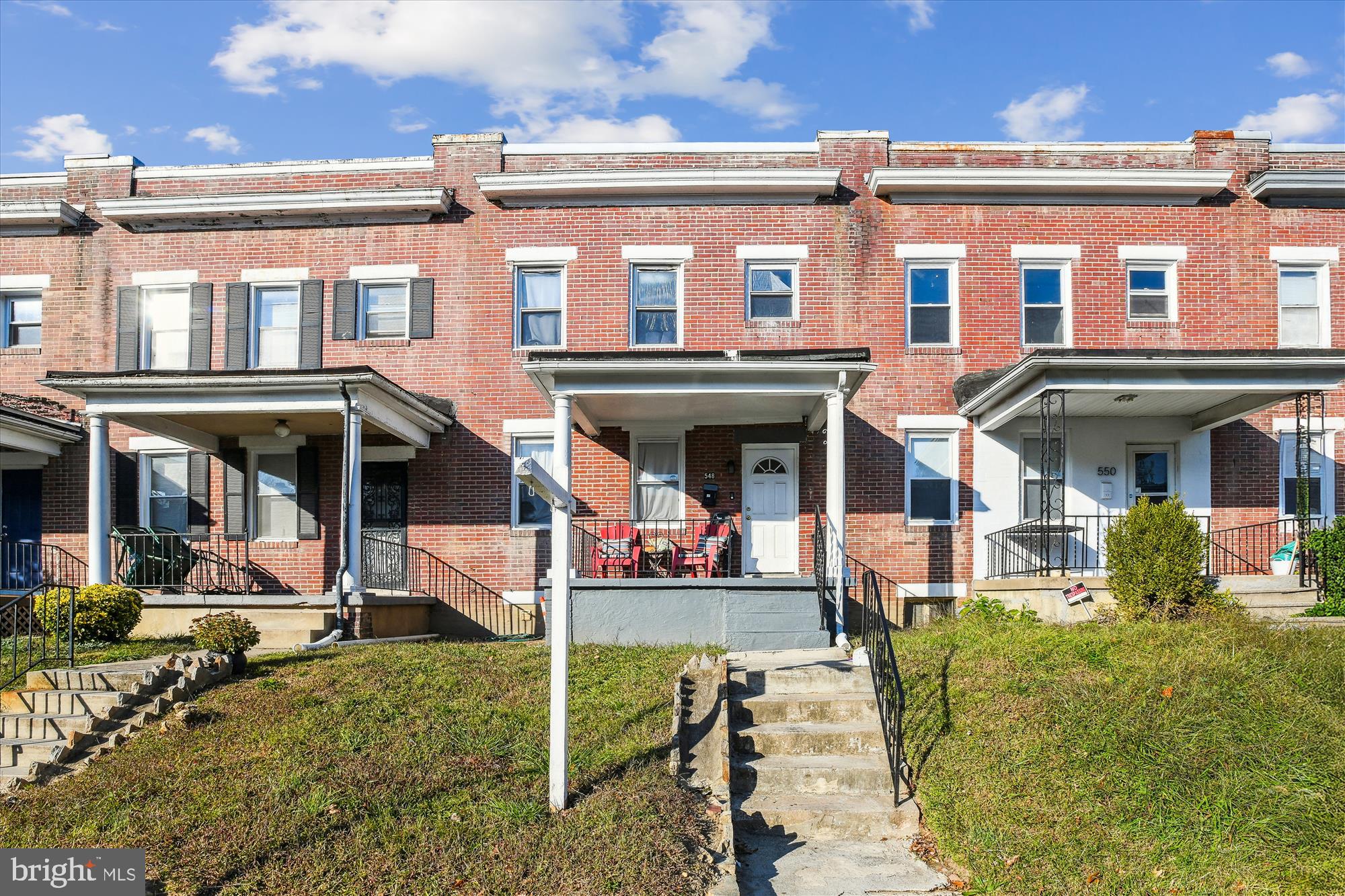 front view of a brick house with a porch