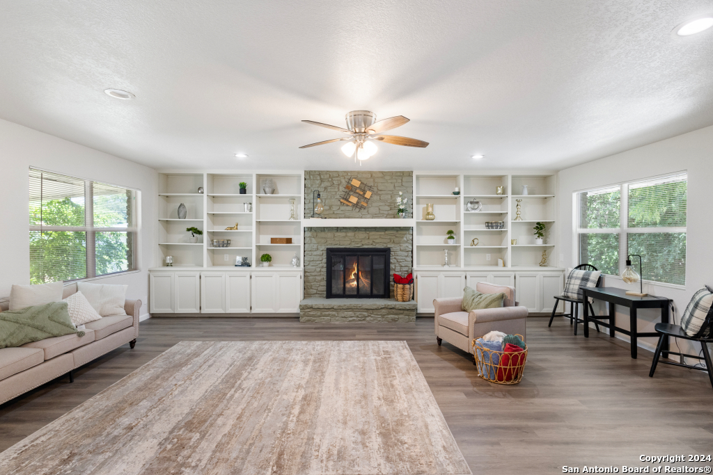 a living room with furniture and a fireplace