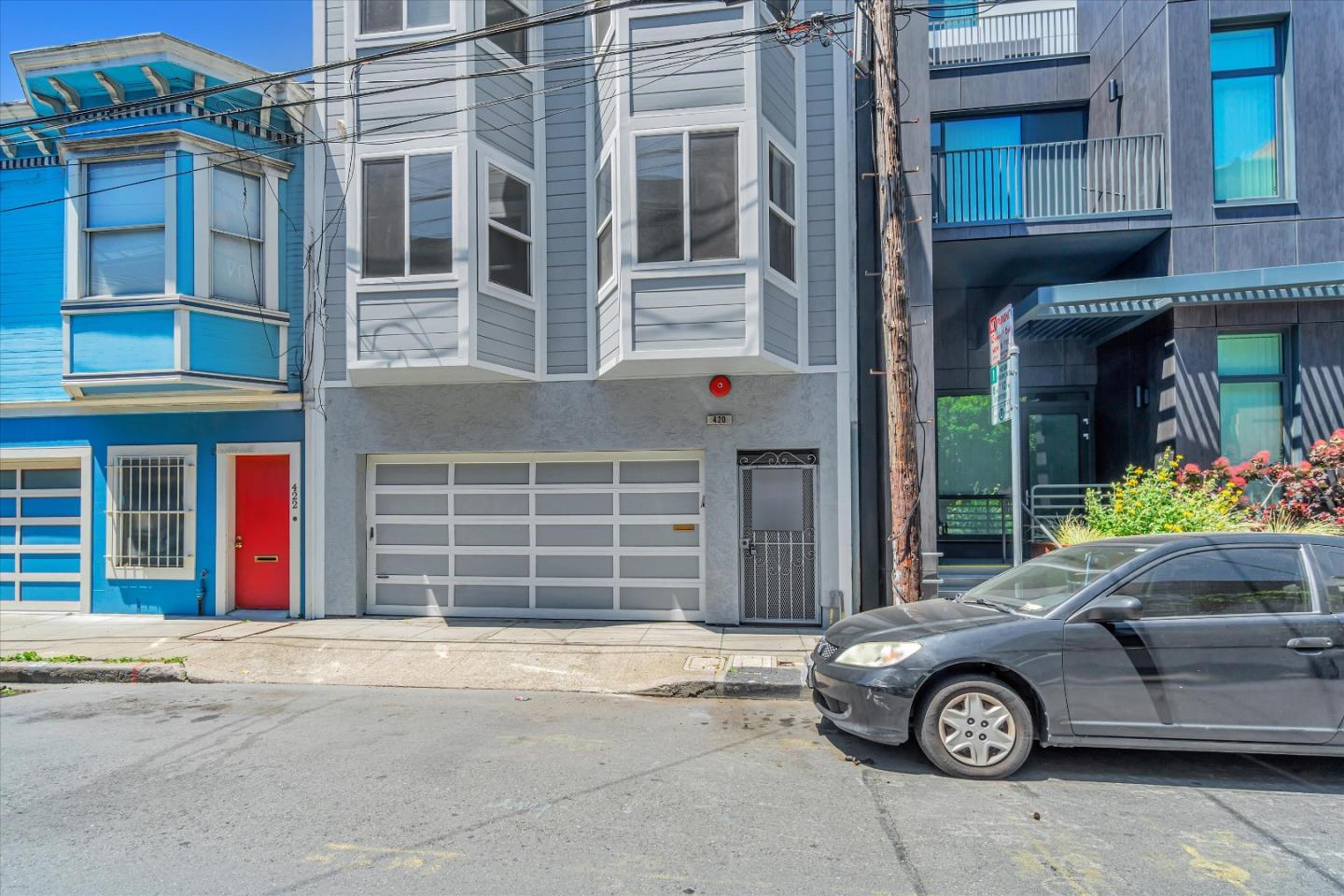 a front view of a house with a parking space