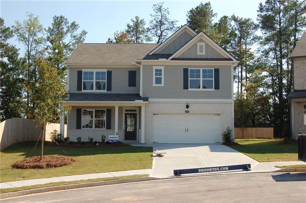 a front view of a house with a yard and garage